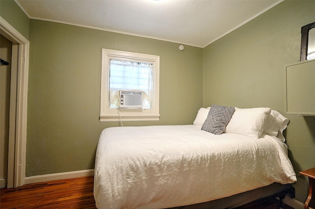 bedroom featuring ornamental molding, cooling unit, and dark wood-type flooring