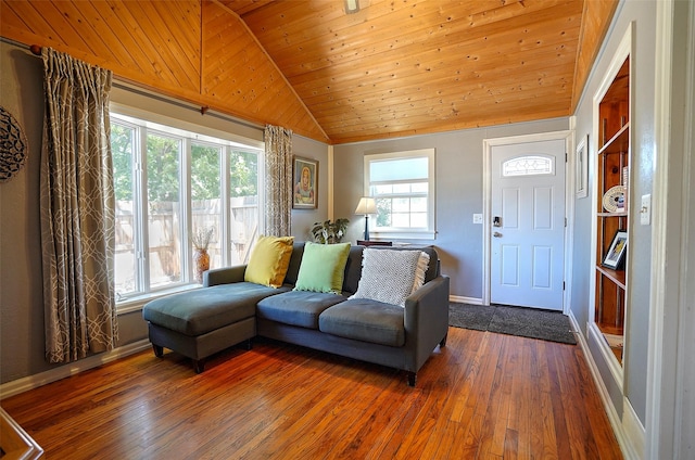 living room featuring a healthy amount of sunlight, dark hardwood / wood-style floors, and vaulted ceiling