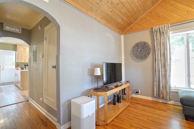 living room with light hardwood / wood-style flooring, crown molding, and wood ceiling