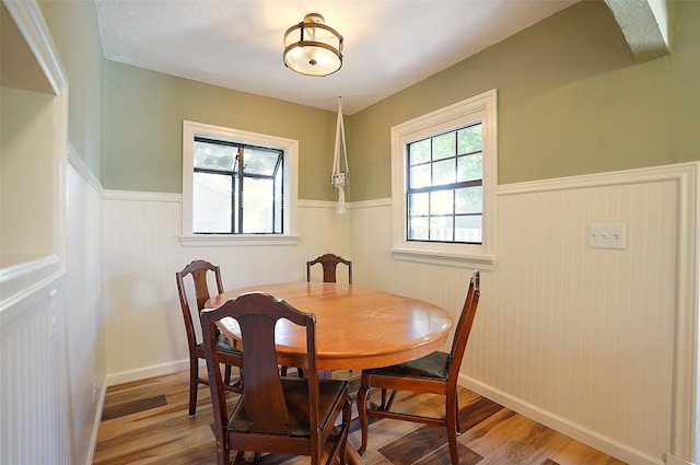 dining space with hardwood / wood-style flooring