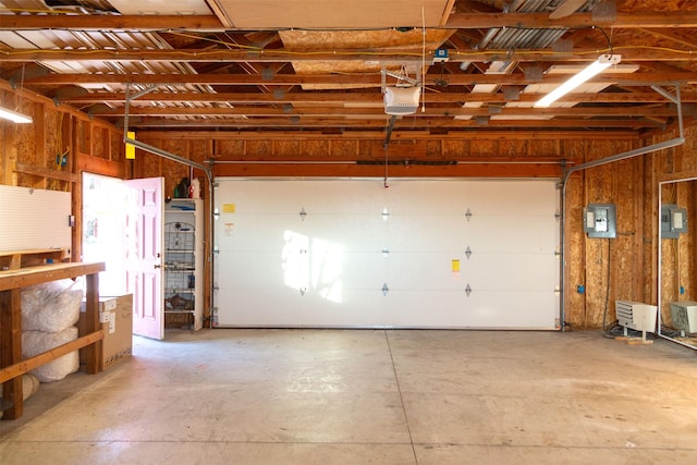 garage with electric panel and a garage door opener