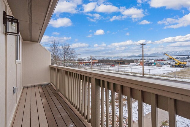 view of snow covered back of property