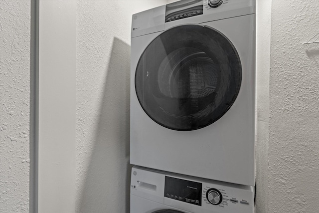 laundry area featuring stacked washer / dryer