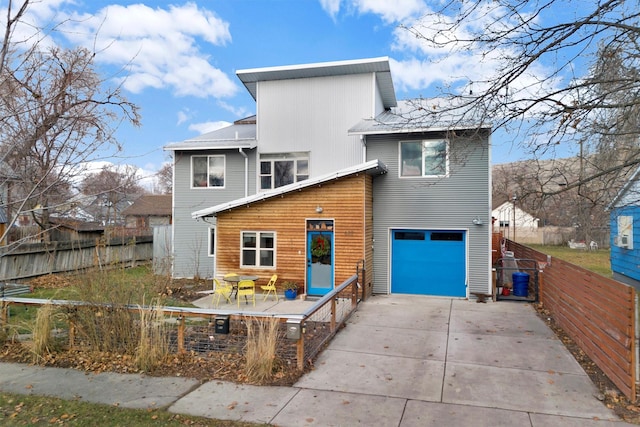 rear view of property featuring a garage