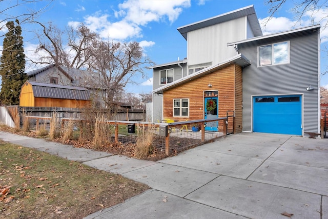 rear view of property with a garage