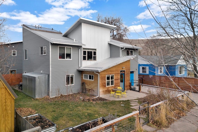 back of house with a yard and a patio