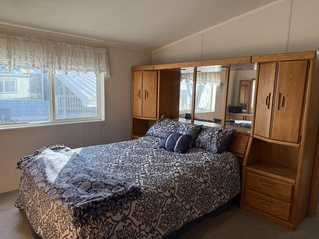 carpeted bedroom featuring a textured ceiling and vaulted ceiling