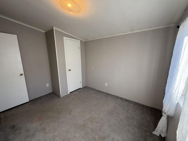 unfurnished bedroom featuring carpet, ornamental molding, and a textured ceiling