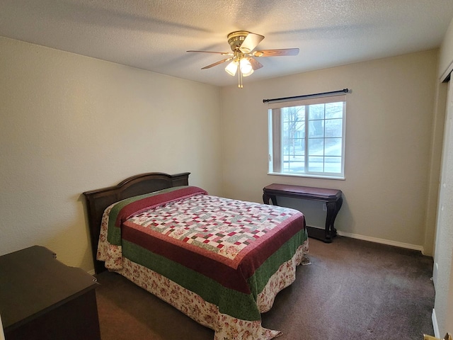 carpeted bedroom featuring ceiling fan and a textured ceiling