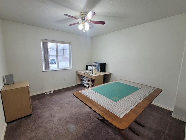 carpeted office with a textured ceiling and ceiling fan