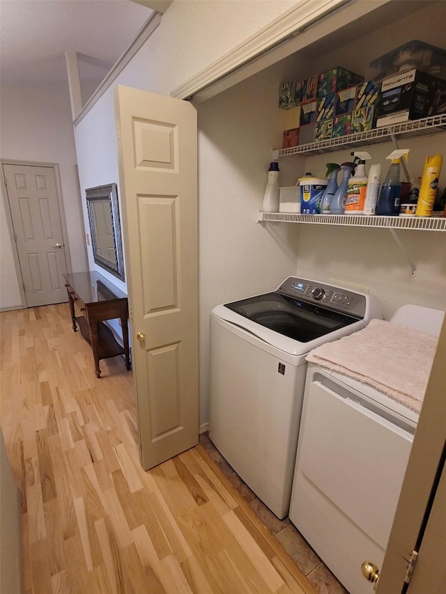 washroom with separate washer and dryer and light hardwood / wood-style floors