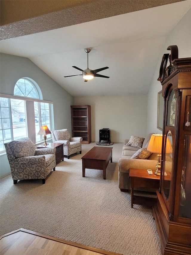 living room featuring wood-type flooring, vaulted ceiling, and ceiling fan