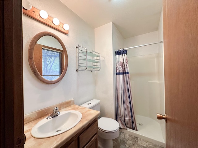 bathroom with vanity, toilet, and walk in shower