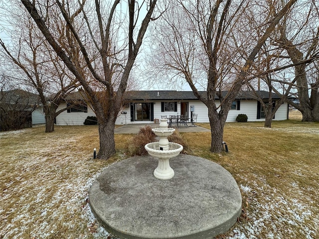 ranch-style home with a patio area and a yard