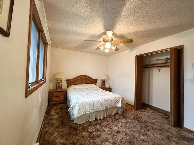 bedroom with ceiling fan, dark carpet, a textured ceiling, and a closet