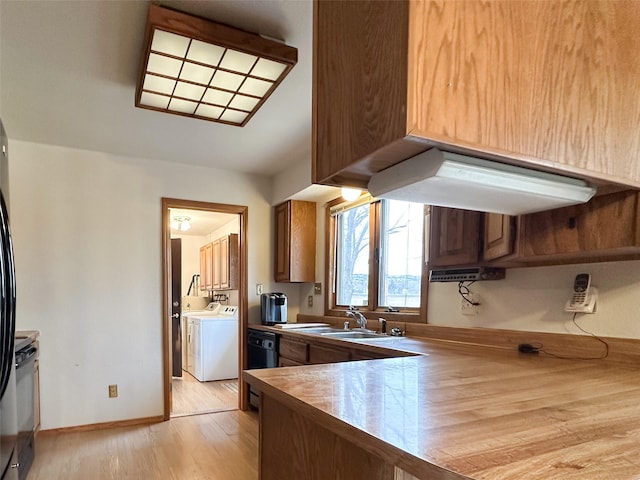 kitchen featuring dishwasher, independent washer and dryer, light hardwood / wood-style flooring, and sink