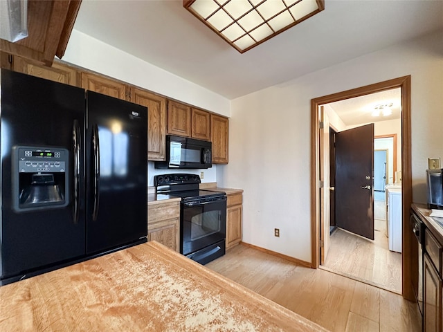 kitchen featuring light hardwood / wood-style floors and black appliances