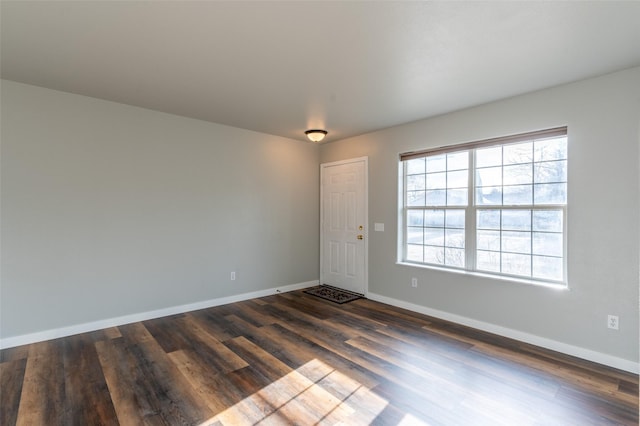 spare room with dark wood-type flooring