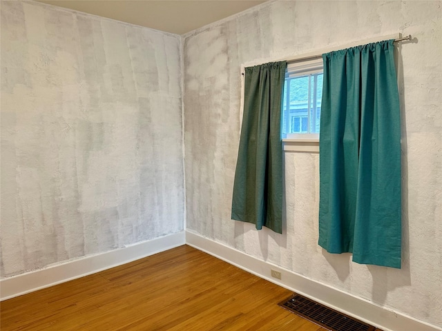 spare room with hardwood / wood-style flooring