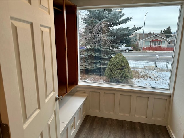 unfurnished room with plenty of natural light and dark wood-type flooring