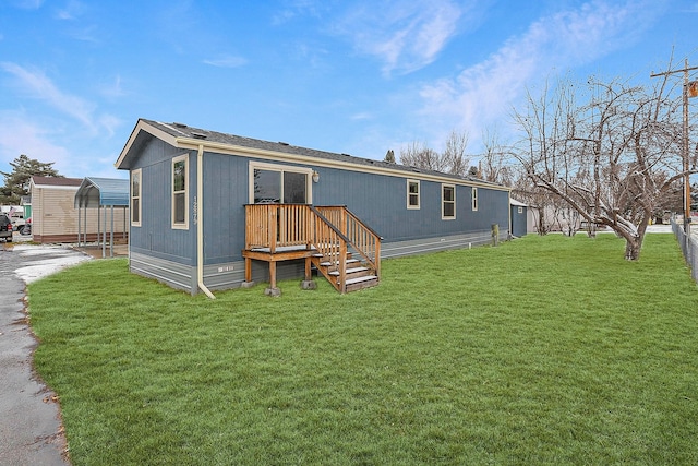 rear view of house with a lawn and a carport