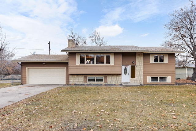 bi-level home featuring a garage and a front yard