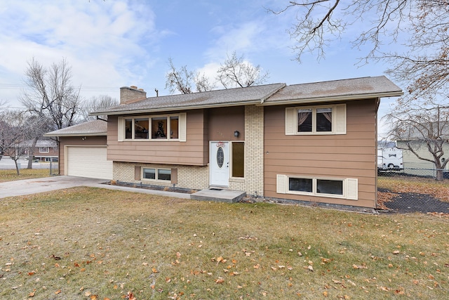 split foyer home with a front yard and a garage