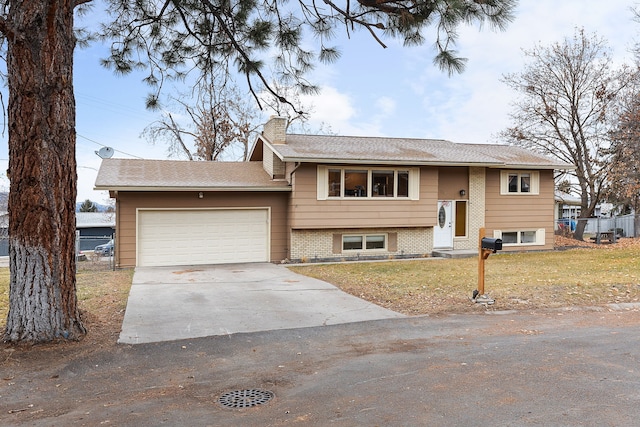 bi-level home with a front yard and a garage