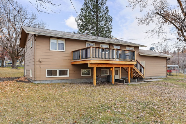 rear view of house featuring a yard and a deck