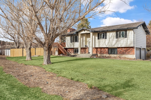 raised ranch with a front yard and a garage