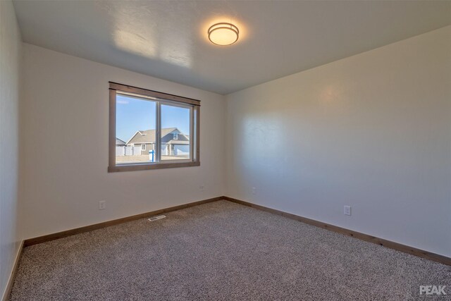 unfurnished bedroom featuring light carpet and a closet