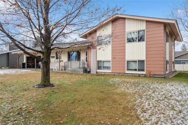 view of property exterior with a lawn, covered porch, and a carport