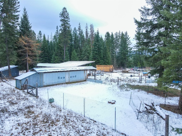 yard covered in snow featuring an outdoor structure