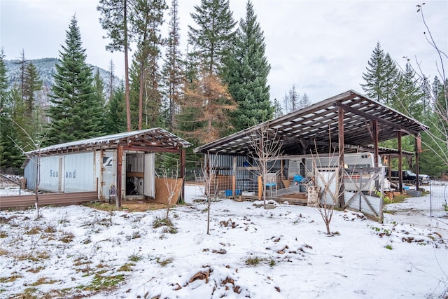 snowy yard featuring an outdoor structure