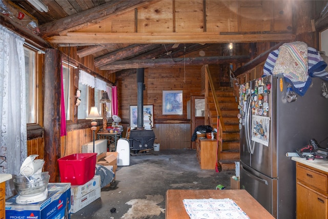 miscellaneous room with a wood stove, wooden walls, wood ceiling, and lofted ceiling with beams