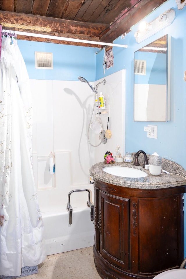 bathroom featuring beamed ceiling, shower / bath combo with shower curtain, wood ceiling, and vanity