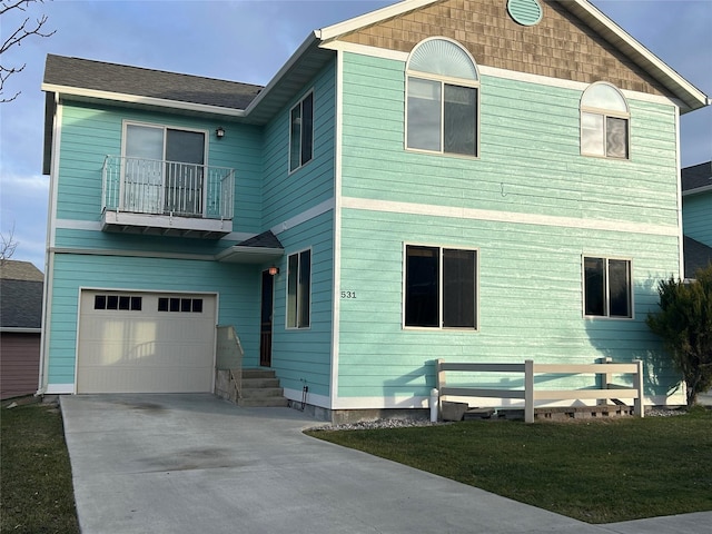 view of front of property featuring a balcony, a front lawn, and a garage