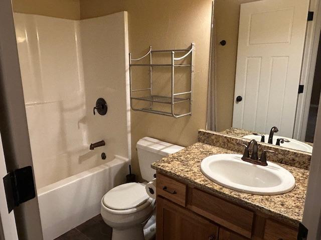 full bathroom featuring tile patterned floors, vanity, shower / bathtub combination, and toilet