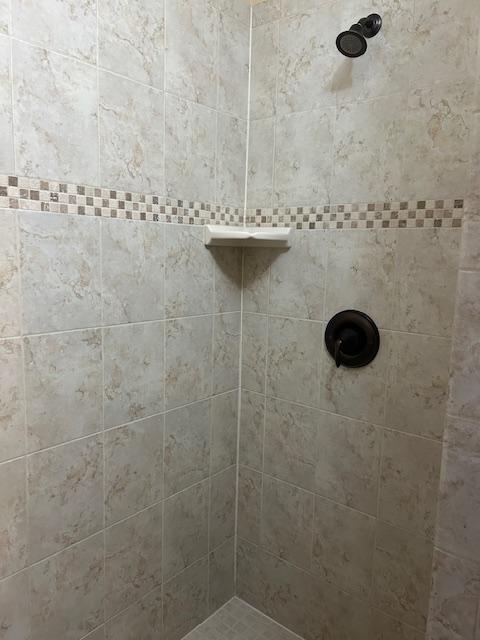 bathroom with tiled shower