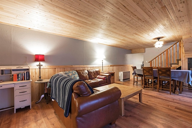 living room with hardwood / wood-style flooring, wooden ceiling, and wooden walls