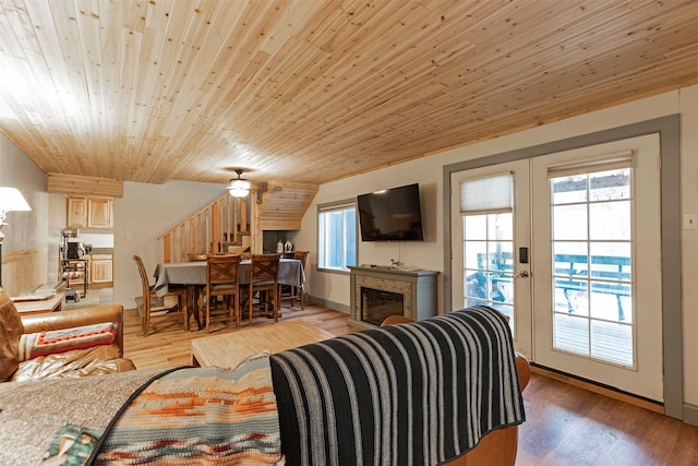 living room featuring ceiling fan, wooden ceiling, french doors, and light hardwood / wood-style flooring