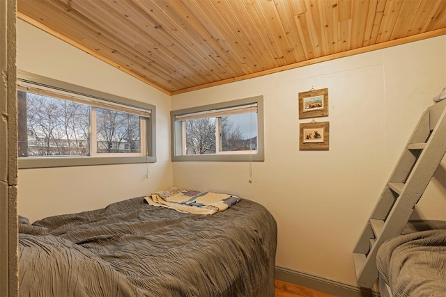 bedroom featuring hardwood / wood-style flooring, wooden ceiling, and vaulted ceiling