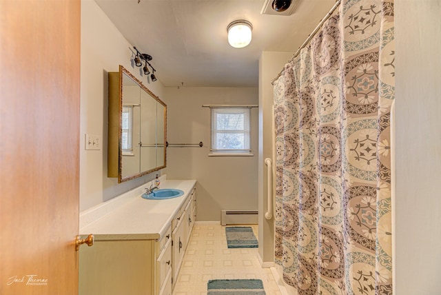 bathroom featuring a baseboard radiator, visible vents, vanity, baseboards, and tile patterned floors