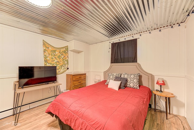 bedroom featuring a baseboard radiator and light wood-style flooring