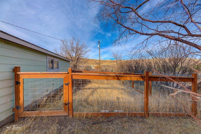 view of gate with fence