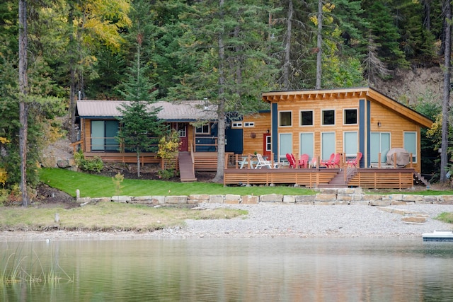 view of front of home with a deck with water view