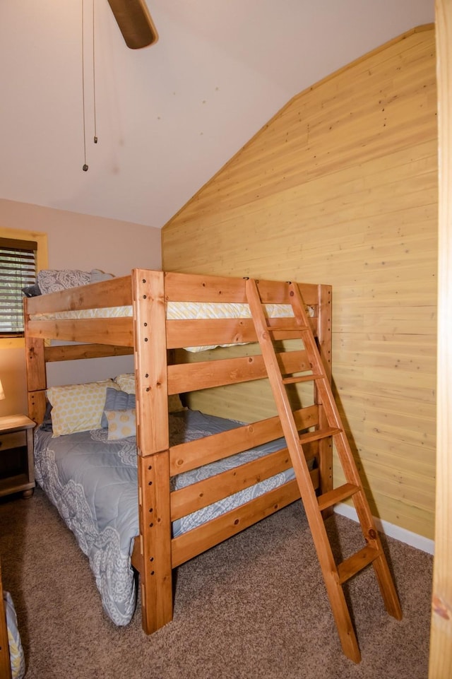 1226 Echo Lake Rd, Bigfork, MT 59911 - carpeted bedroom featuring wooden walls, lofted ceiling, and ceiling fan