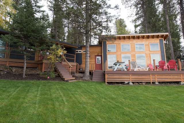 1226 Echo Lake Rd, Bigfork, MT 59911 - back of property featuring stairs, a deck, and a lawn