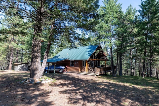 log cabin featuring a carport