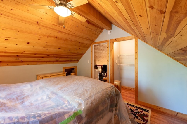 bedroom featuring wooden ceiling, lofted ceiling with beams, hardwood / wood-style flooring, ceiling fan, and a closet